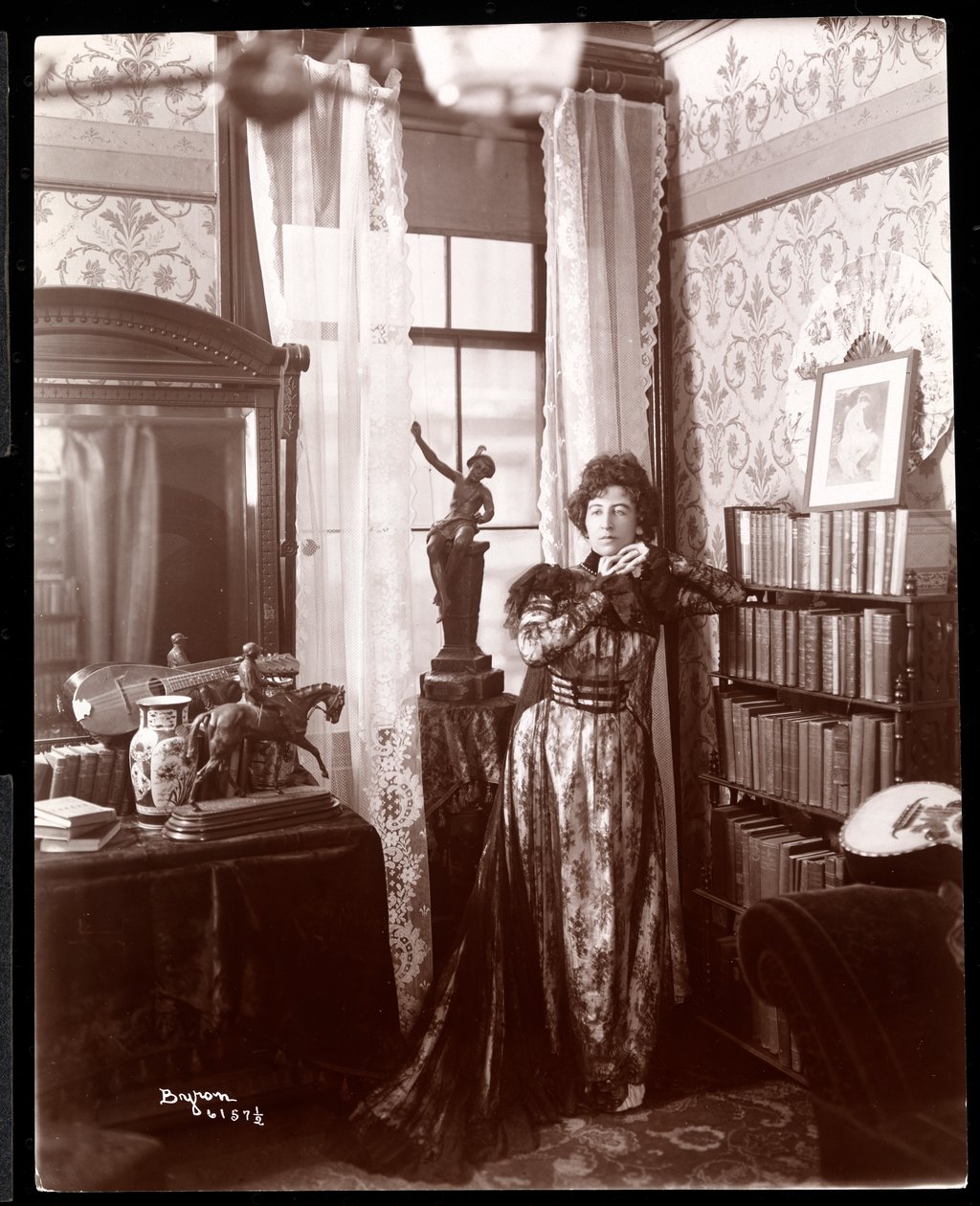 Anita Chartres standing in the corner of a room, c.1898 (silver gelatin print) by Byron Company
