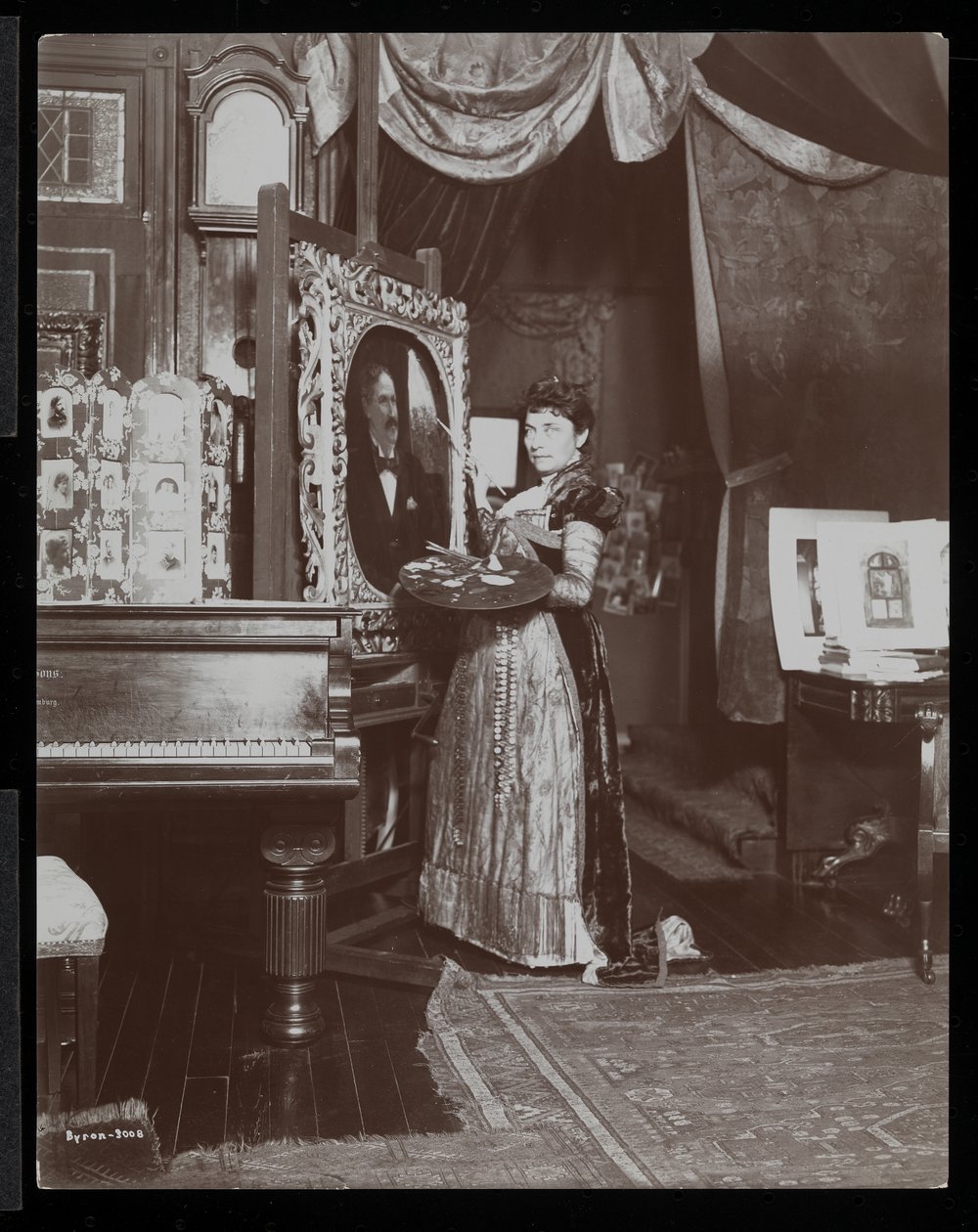 Artist Mary Tillinghast painting a portrait in her studio, New York, c.1897 (silver gelatin print) by Byron Company