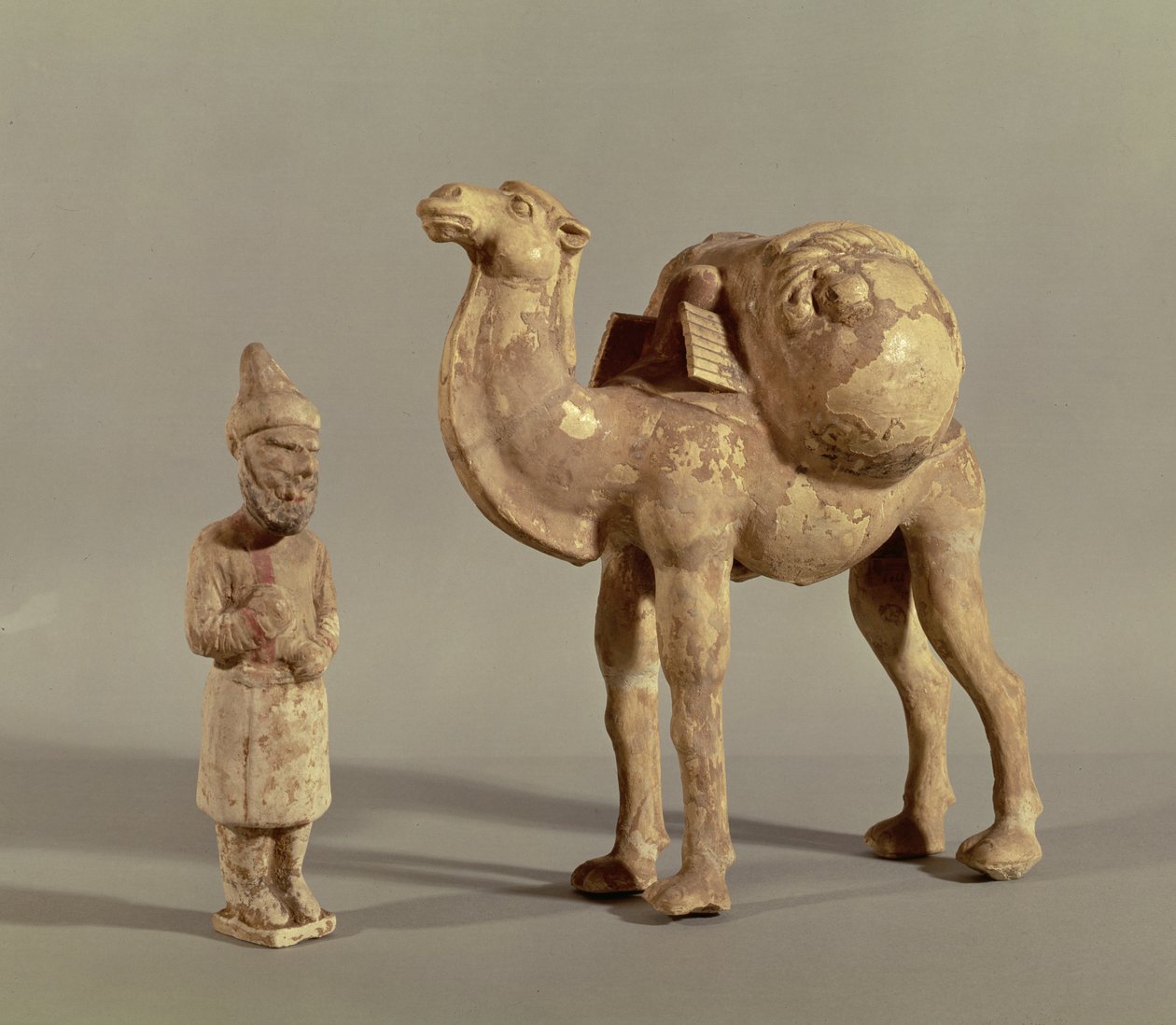 Funerary statuettes of a laden camel and a barbarian caravanner, Tang Dynasty (618-907)  by Chinese School
