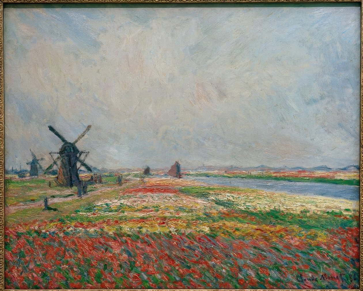 Leiden yakınlarındaki çiçek tarlaları ve yel değirmenleri by Claude Monet