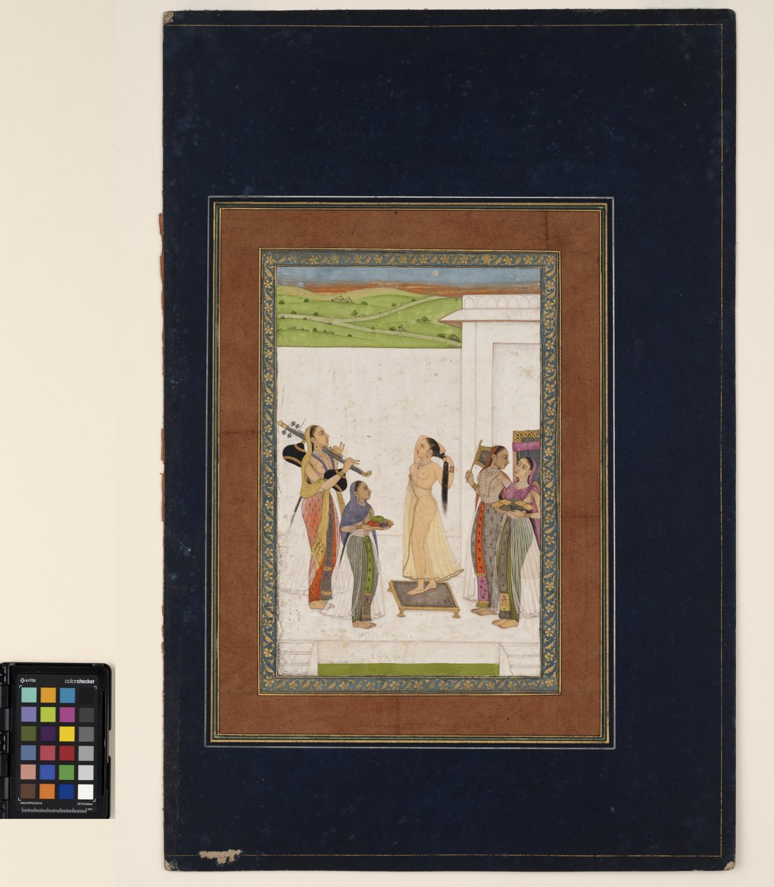 Tuvaletini tamamlayan bir kadın, c.1725 (kağıt üzerine opak sulu boya ve altın, bir albüm sayfasına monte edilmiş) by Deccani School