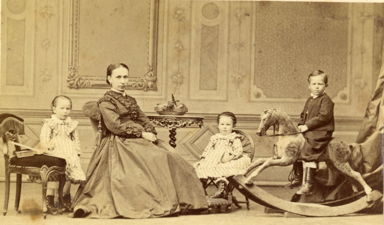 Young boy on rocking horse surrounded by his family, 1860s (albumen print) by Georg Friedrich Brandseph