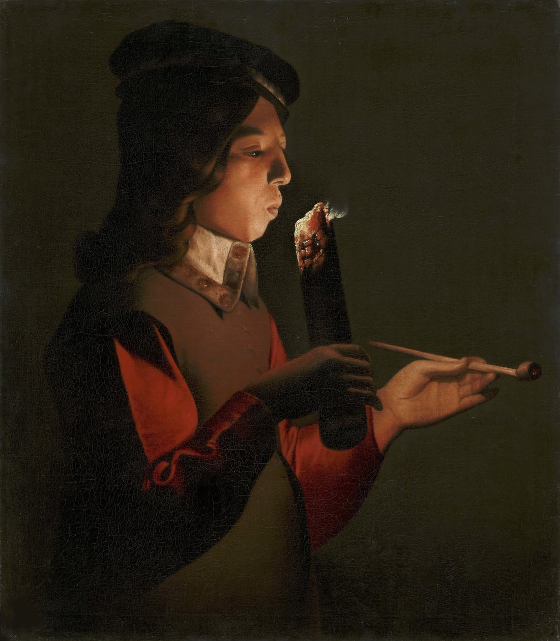La Tour, Georges, de (1583-1652) tarafından, pipolu genç bir çocuk, bir ateş parçasına üfler. tuval üzerine yağlıboya by Georges de La Tour