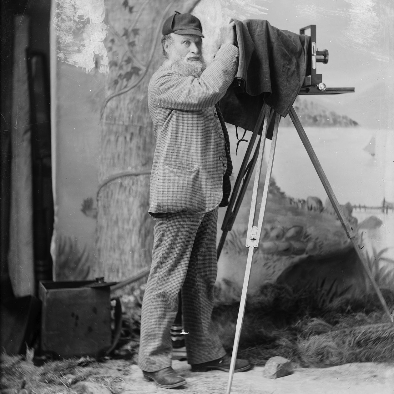 Photographer Richard Maynard with field camera on tripod inside Hannah Maynards studio, Victoria, BC, 1890s (bw photo) by Hannah Maynard