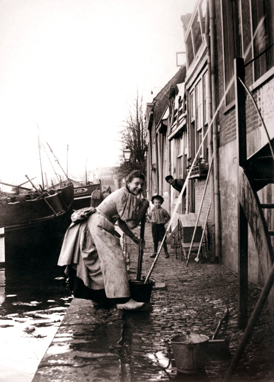 Woman mopping the street, Dordrecht, Netherlands, 1898. by James Batkin