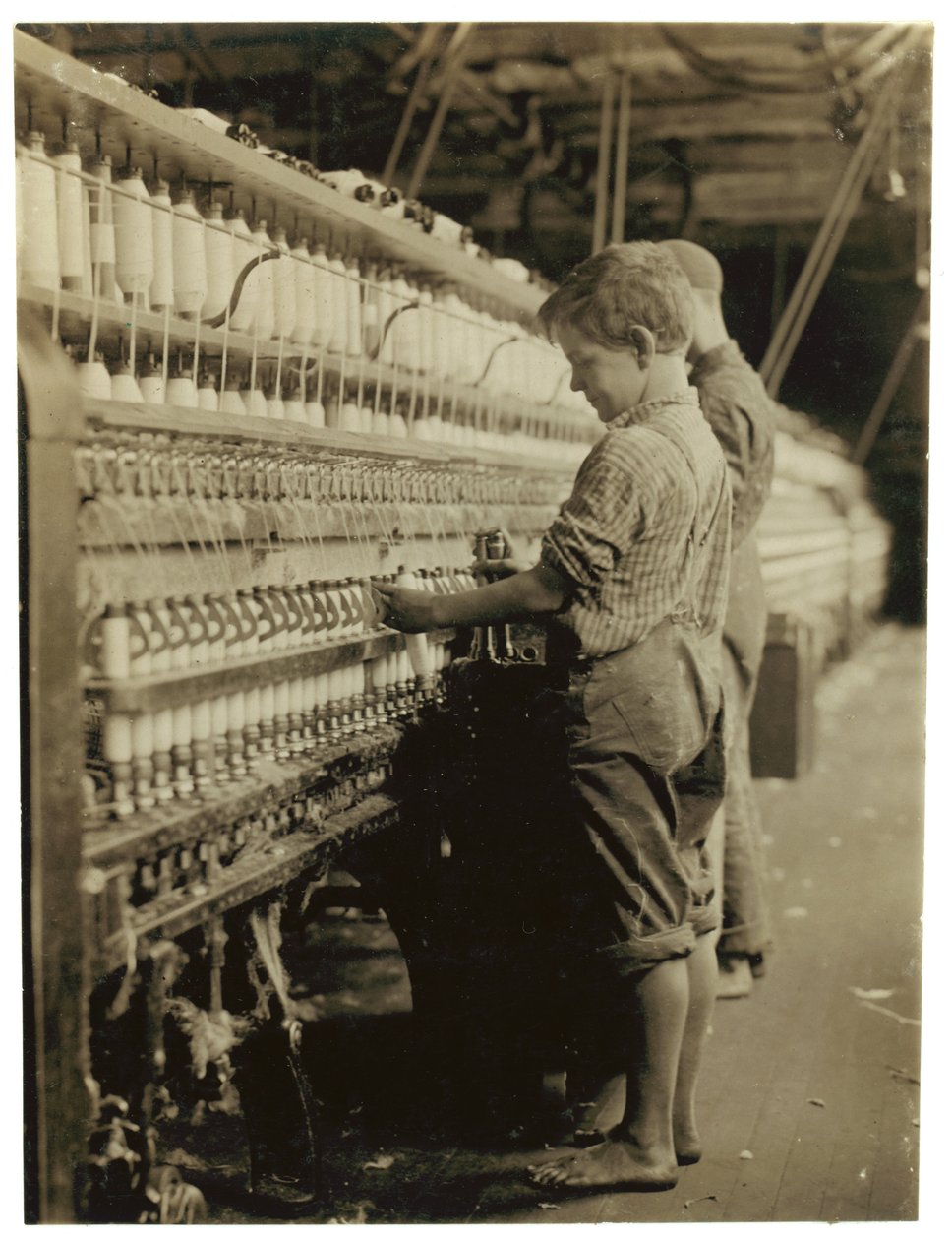 Young doffers replacing full bobbins at North Pownal, Vermont, 1910  by Lewis Wickes Hine