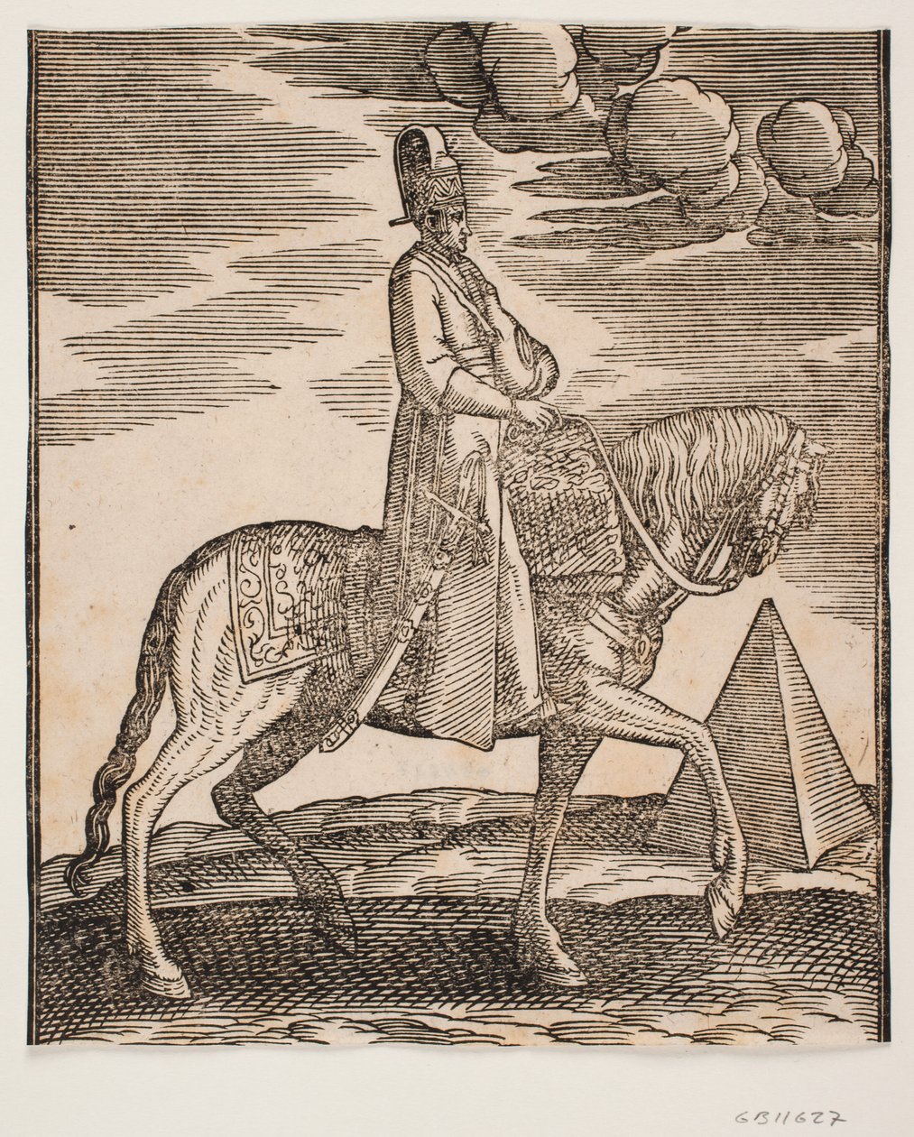 Boynunda bir matara olan binici, profili sağa doğru; sağ tarafında bir kılıç ve eyerin üzerine serilmiş, önünde bagaj; sağda, arka planda bir piramit by Melchior Lorck