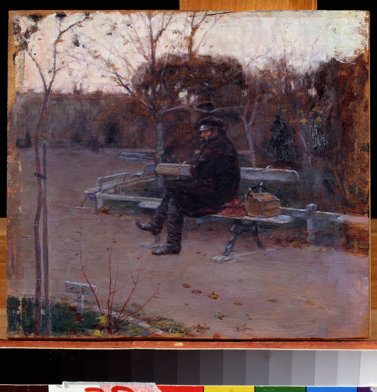 Bulvarda (Bulvarda). Soğukta bir bankta oturan yalnız bir adam, yanında bir sırt çantası ve bir alet çantası. Tablo Pyotr Alexandrovich Nilus (Pierre Nilous) (Nilouss) (1869-1940/1943), tuval üzerine yağlı boya by Peter Alexandrovich Nilus