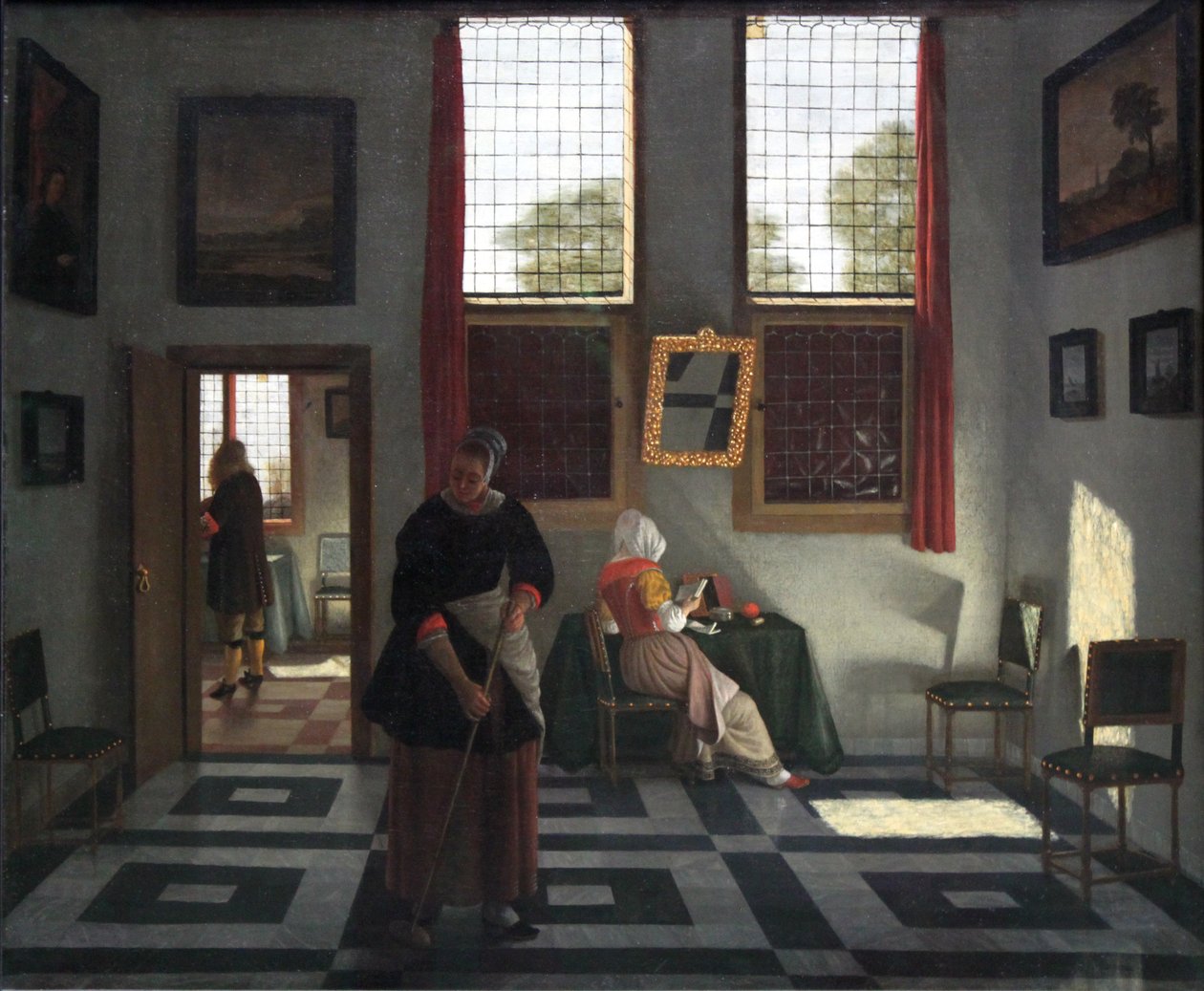 Ressamlı iç mekan, okuyan kadın ve temizlikçi hizmetçi by Pieter Janssens