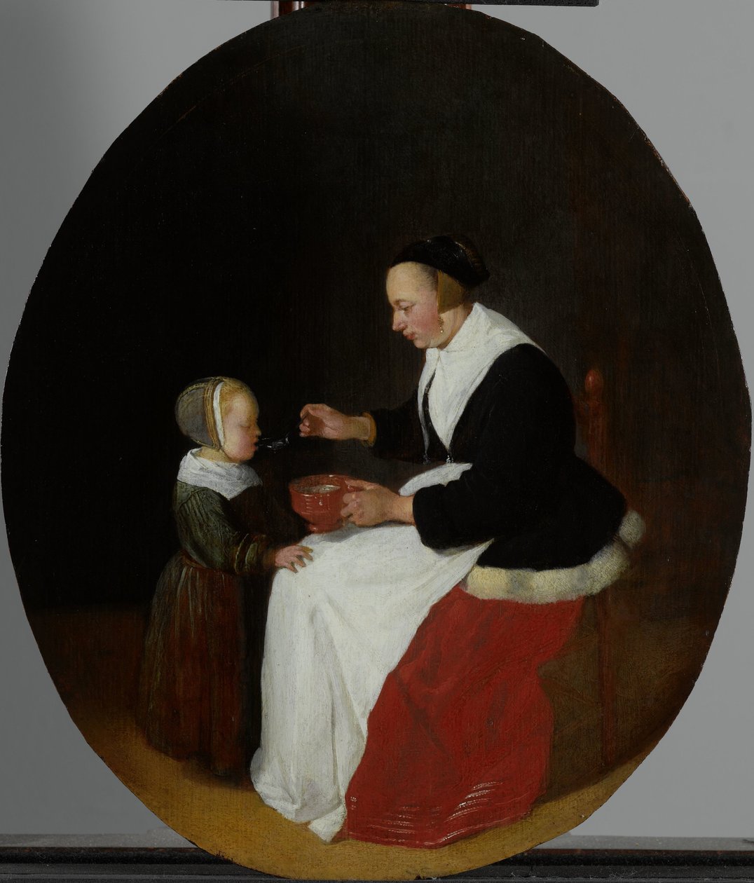 Çocuğuna yulaf lapası besleyen anne by Quiringh Gerritsz. van Brekelenkam