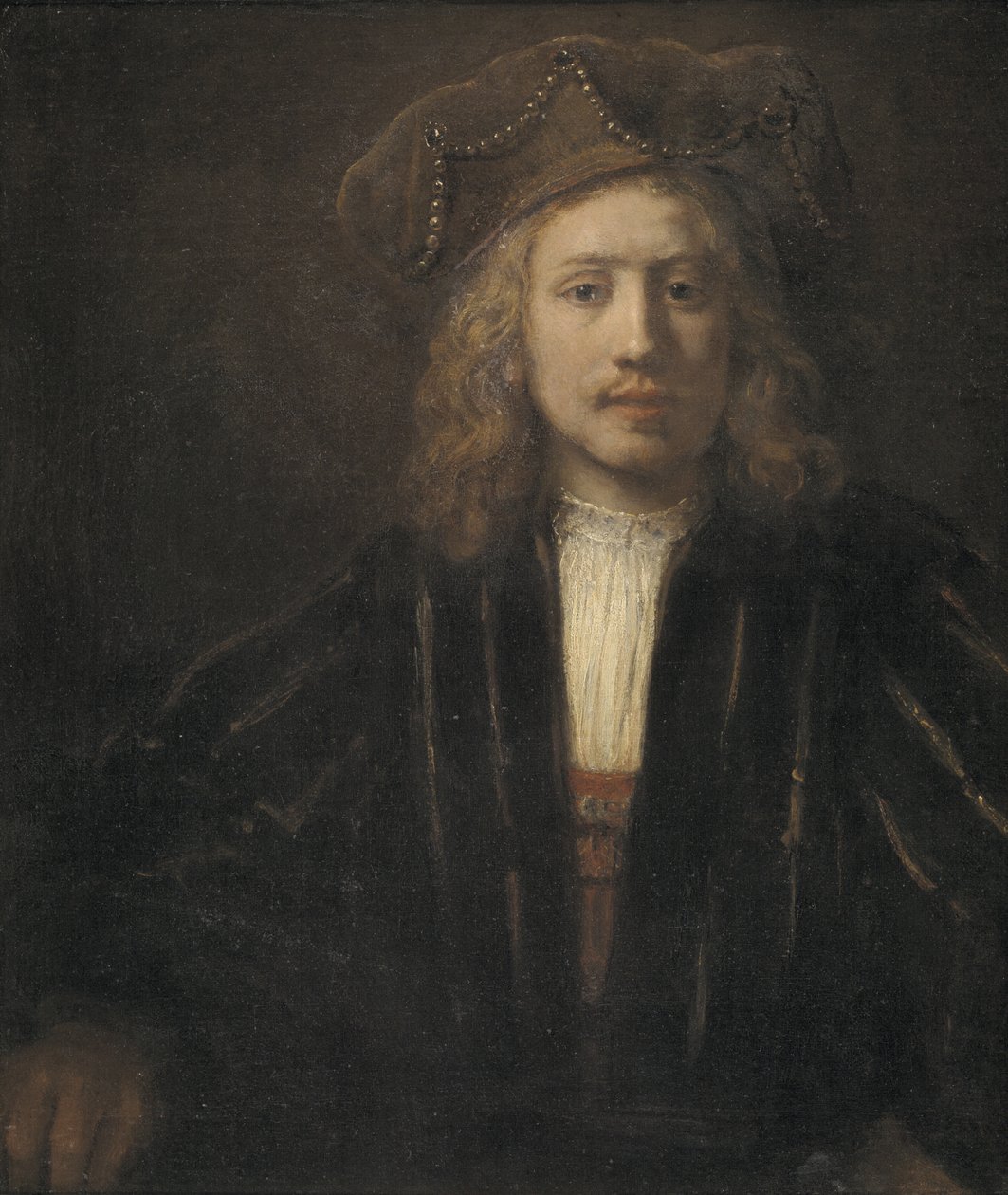 İnci işlemeli şapkalı genç adam by Rembrandt van Rijn