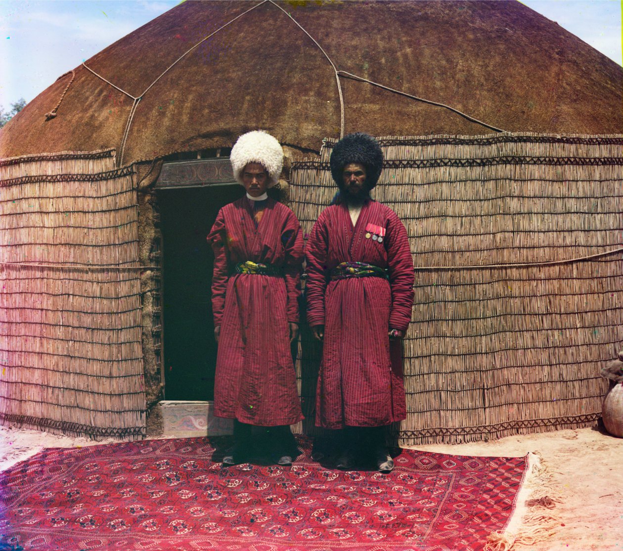 Yurt Önünde Bir Halının Üzerinde Duran İki Adam by Sergei Mikhailovich Prokudin Gorskii