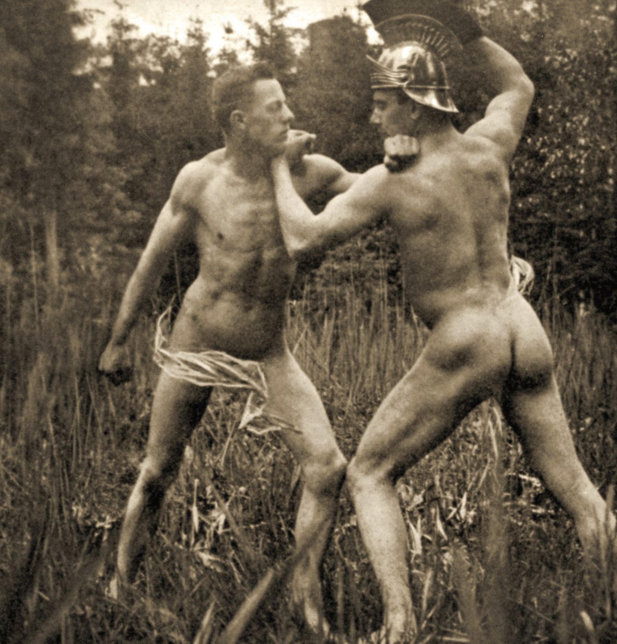 Fightingbattle pose with a Roman Helmet, c.1910 (sepia photo) by Unknown