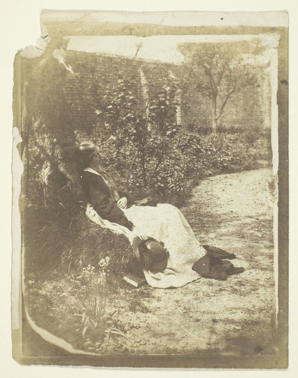 Bayan Craik Şapka ve Kitapla Bahçede Yatarken by Unknown