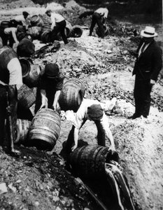 Bir ABD Federal Ajanı, Amerikan Yasağı döneminde (1920-33) bira fıçılarının imhasını denetler (s/b fotoğraf) by American Photographer