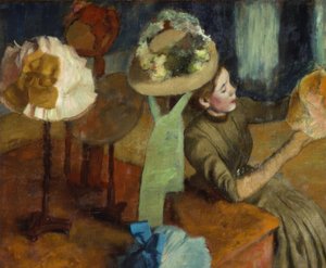 şapka yapımcısında by Edgar Degas