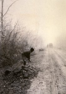 Sabah sisine bürünmüş bir köy yolu. Ön planda bir adam taş kırıyor. by Unbekannter Künstler