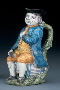 Soluk mangan yüzlü ve elleri olan Toby sürahisi, yıkanmış mavi ceket ve pantolonlu ve yeşil yelekli, tutma yeri ve boş küresel devetüyü renkli sürahi, c.1800 by Unbekannt