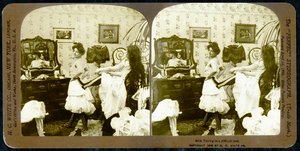 Stereoscopic card depicting a woman being laced into a corset, c.1900 (sepia photo) (see also 473244) by Vermont, USA H.C. White Company
