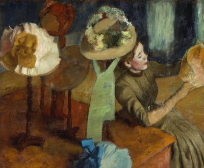 şapka yapımcısında by Edgar Degas
