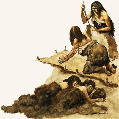 A Stone Age family scrape skins to make clothing by Peter Jackson