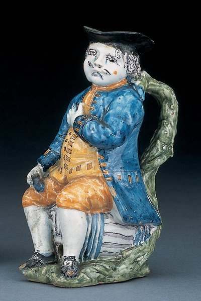 Soluk mangan yüzlü ve elleri olan Toby sürahisi, yıkanmış mavi ceket ve pantolonlu ve yeşil yelekli, tutma yeri ve boş küresel devetüyü renkli sürahi, c.1800 by Unbekannt
