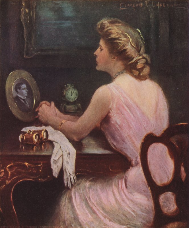 Bir erkeğin, muhtemelen kocasının veya sevgilisinin fotoğrafına bakan tuvalet masasında oturan kadın by Clarence F. Underwood