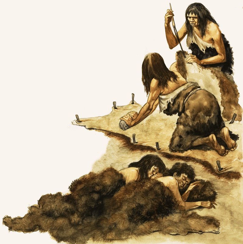 A Stone Age family scrape skins to make clothing by Peter Jackson